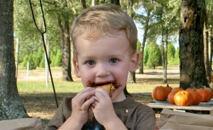 a young boy eating a banana