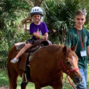 a young boy riding a horse